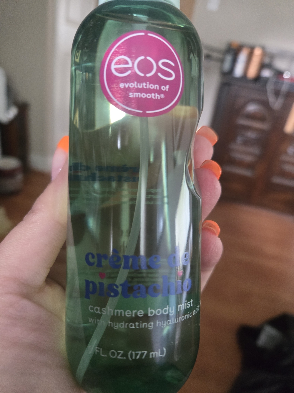 eos Crème de Pistachio Cashmere Body Mist — green with pink logo